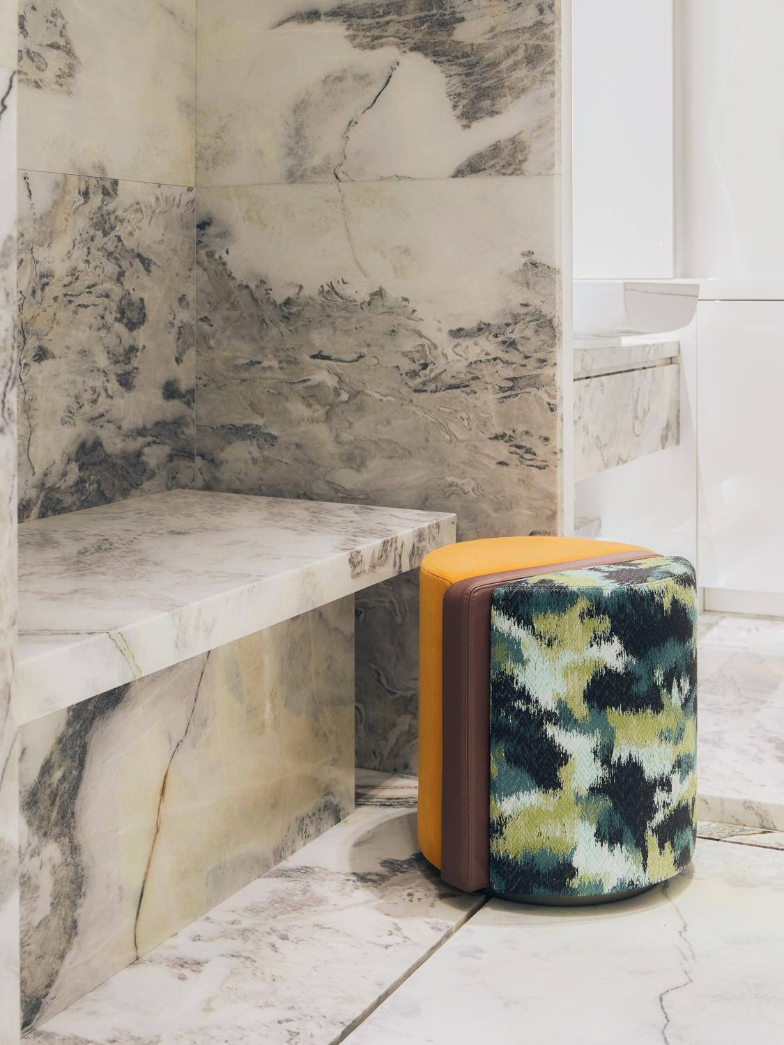 Detail of pouf and marble bathroom
